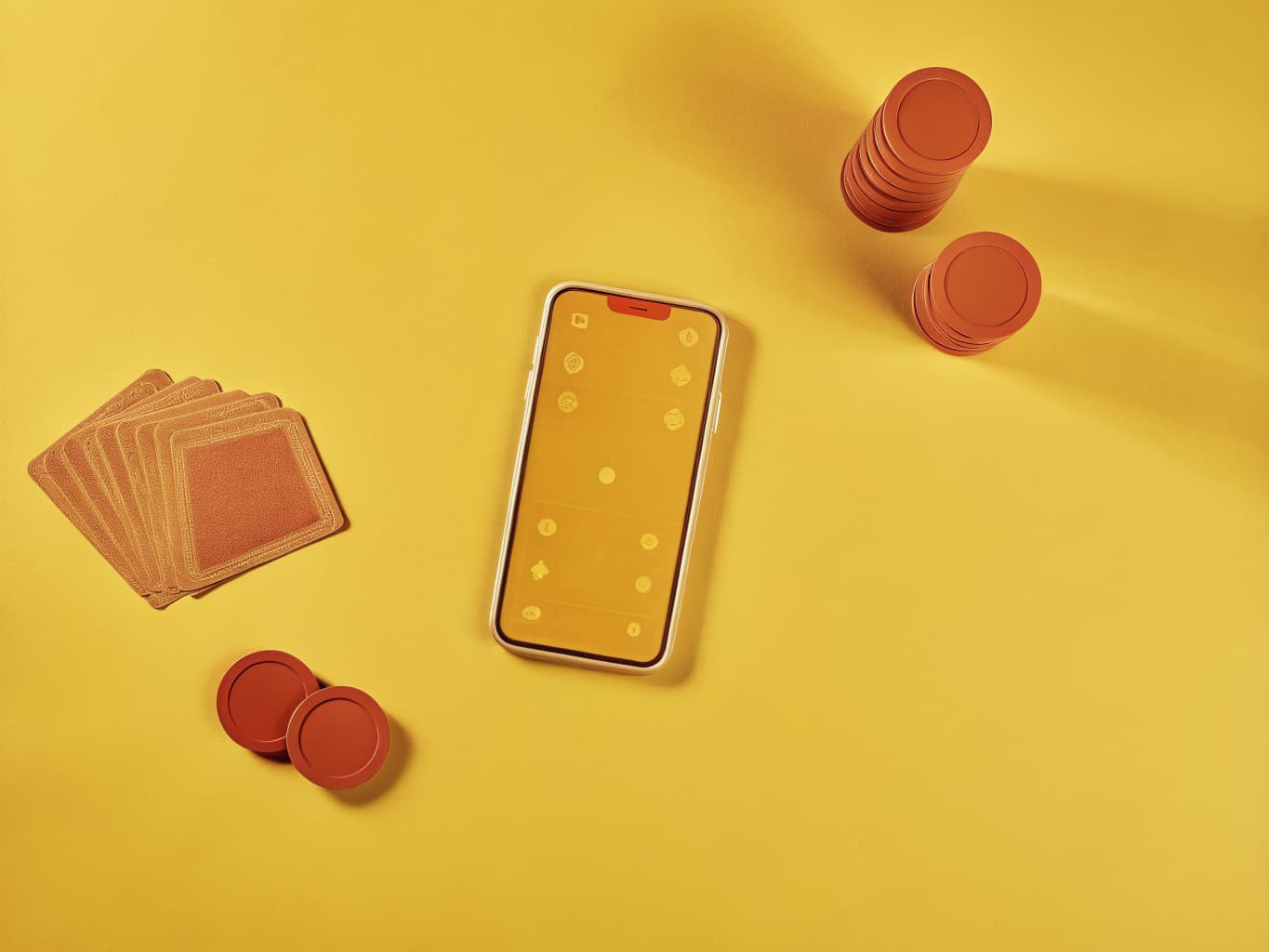 Casino player loyalty and CRM marketing: rewards app on a phone beside poker chips and playing cards