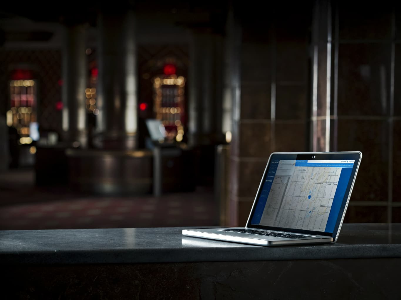 Casino SEO and local search marketing: laptop showing a search results map on a casino resort counter